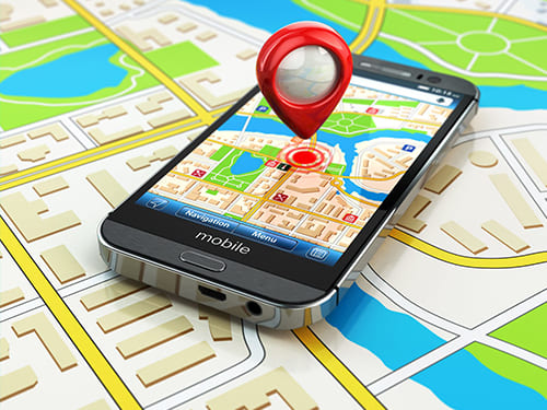 cellulare con icona di posizione adagiato su mappa